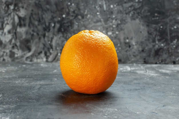 Front close up view of natural organic fresh orange on dark background