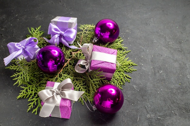 Front close view of colorful gifts and decoration accessories on dark background