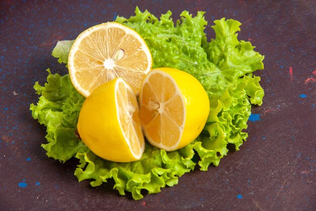 Front close view fresh lemon slices with green salad on dark space