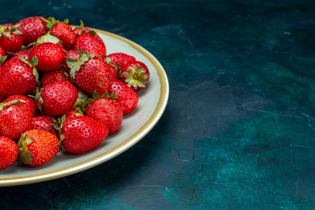 Front close view fresh red strawberries mellow fruits berries inside plate on the dark-blue background berry fruit mellow summer