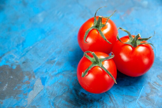 Front close view fresh tomatoes on blue table