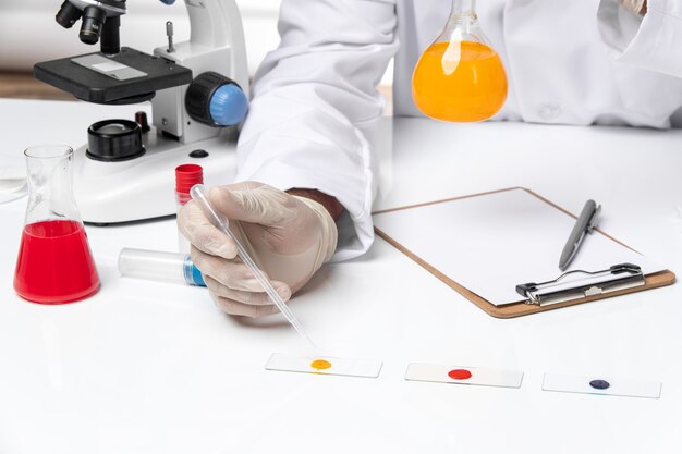 Front close view male doctor in white medical suit on white space