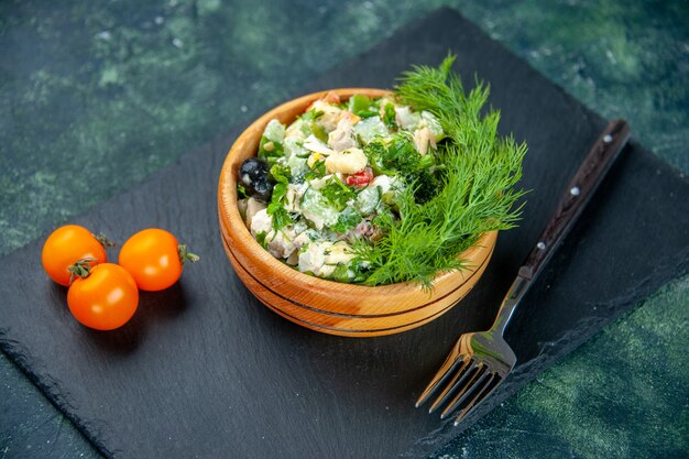 front close view vegetable salad with greens and garlic on a dark blue background