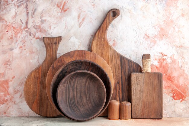 Front close view of wooden cutting boards salt pepper pots on colorful table