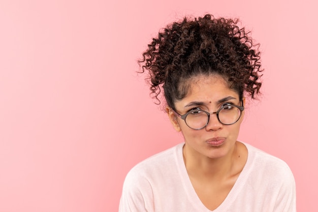 Free photo front close view of young female confused on pink