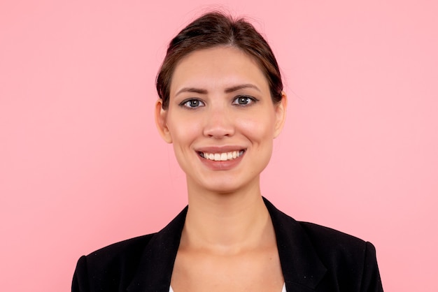 Free photo front close view young female in dark jacket smiling on pink background