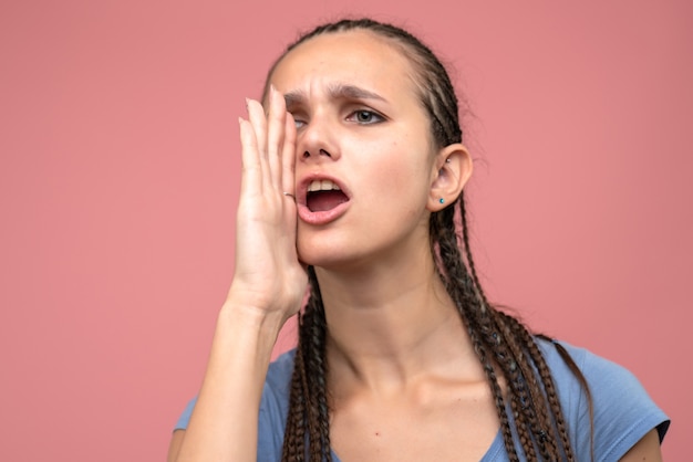 Front close view of young girl calling on pink