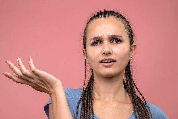 Front close view of young girl confused on pink