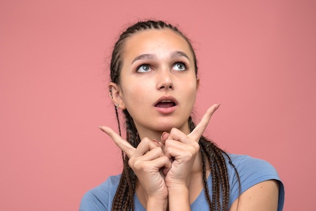 Front close view of young girl dreaming on pink