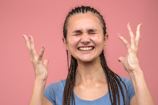 Front close view of young girl nervous on pink