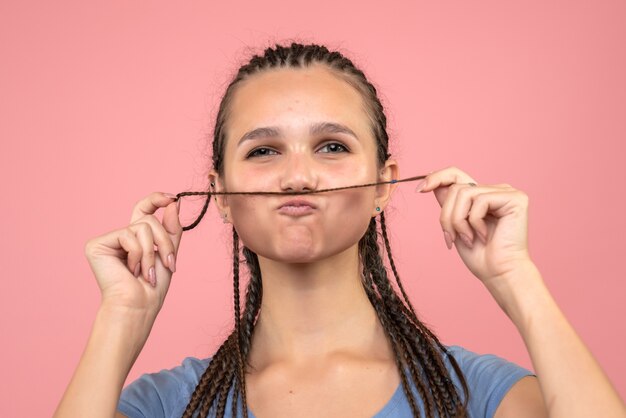 Front close view of young girl on pink