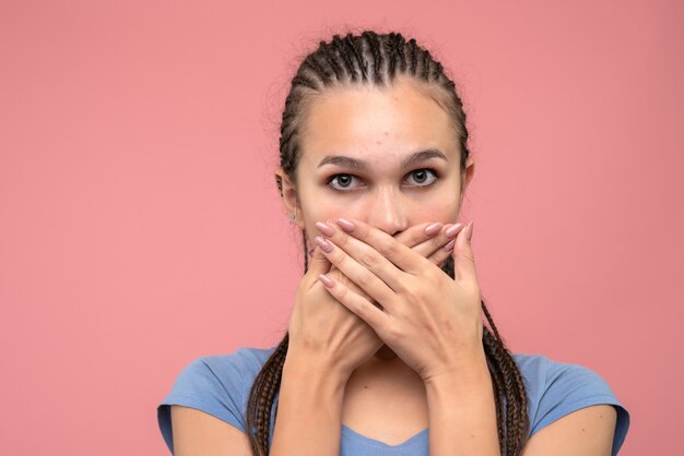 Front close view of young girl shocked on pink