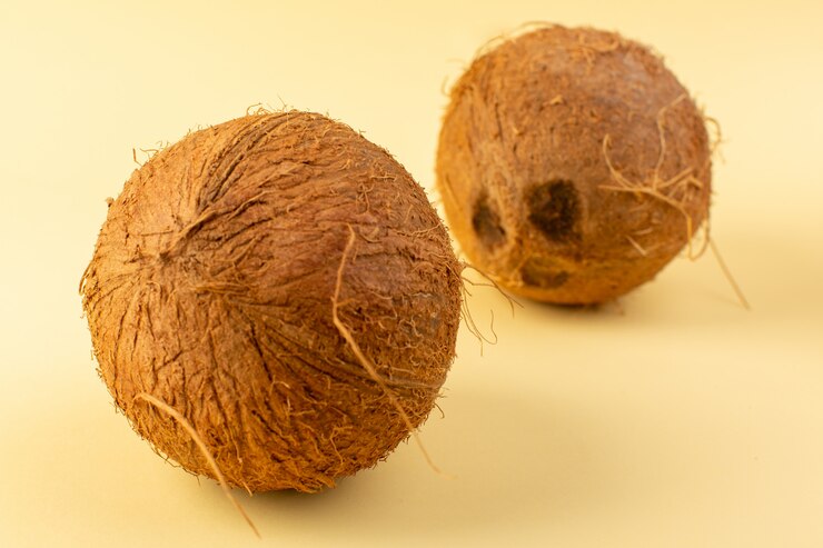 Free Photo a front closed up view coconuts whole milky fresh mellow isolated on the cream colored background tropical exotic fruit nut