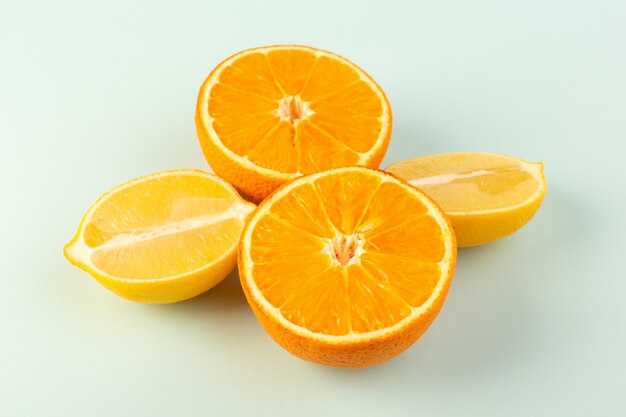 A front closed up view sliced orange fresh ripe juicy mellow isolated half cut pieces along with sliced lemons