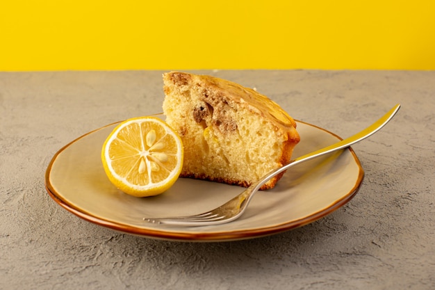 Free photo a front closed up view sweet cake piece delicious yummy choco cake sliced inside beige plate with lemon piece