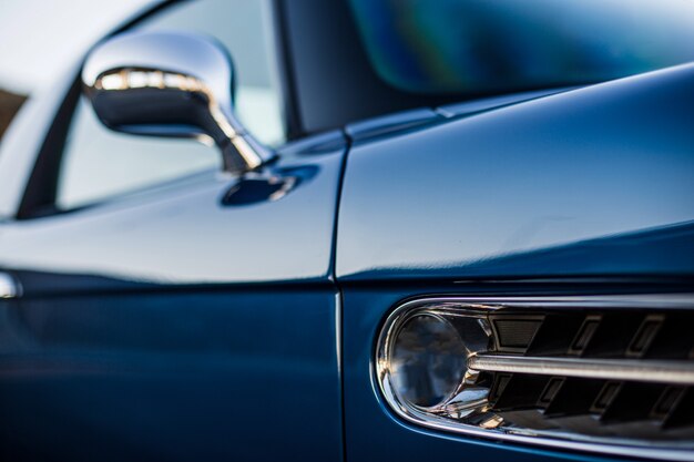 Front exterior windows of a navy blue car