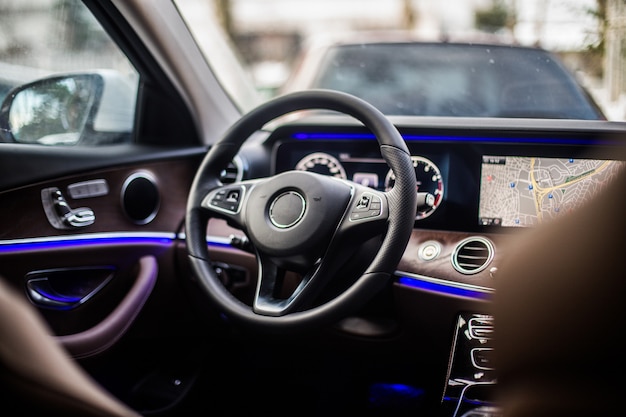 Free photo front left seat and direction control wheel of a car.