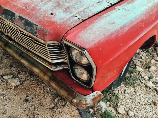 A front of an old vintage red car