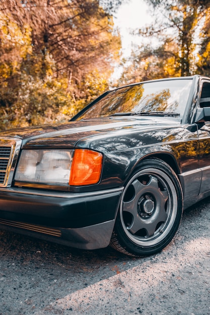 Front side and lights of a vintage black sedan car.