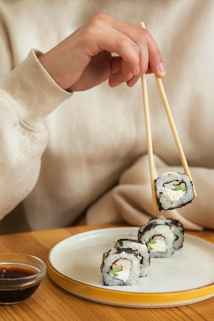 Free photo front view adult holding chopsticks