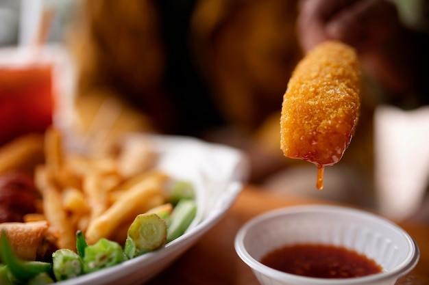 Front view adult holding corn dog