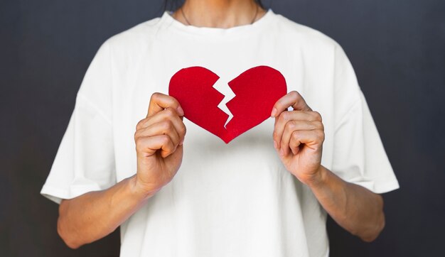 Front view adult holding red broken heart