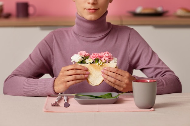 Front view adult holding sandwich