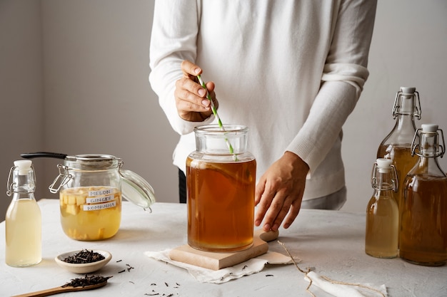 Front view adult making kombucha