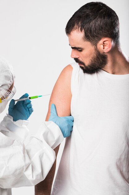 Front view adult male taking a vaccine