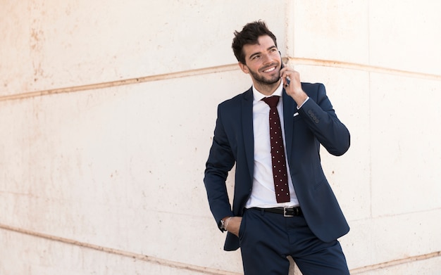 Front view adult in suit talking on the phone