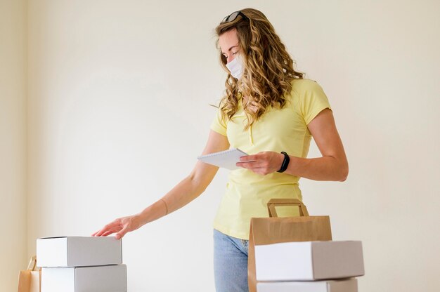 Front view adult woman checking products ordered