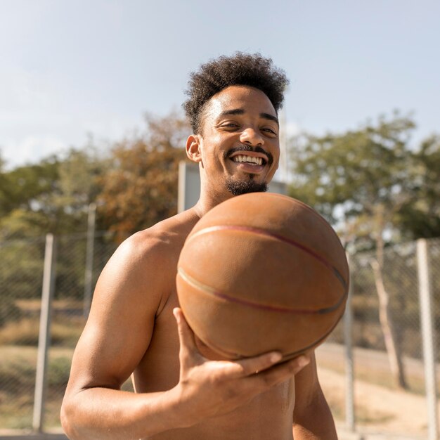 Front view african american man playing basketball shirtless