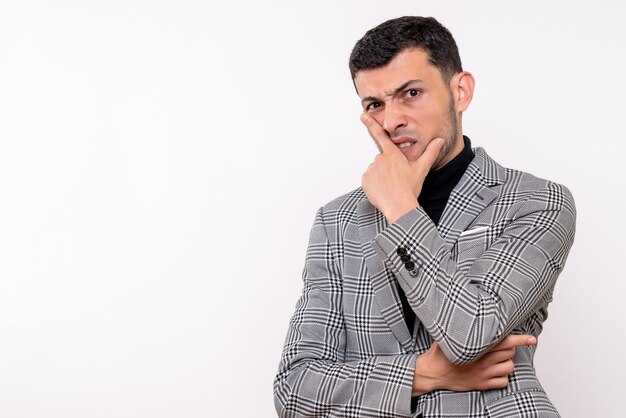 Front view agitated handsome male in suit standing on white isolated background