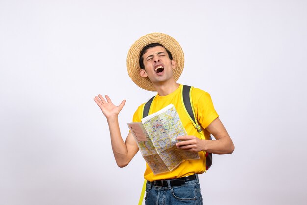 Front view agitated young man with yellow t-shirt and straw hat holding map