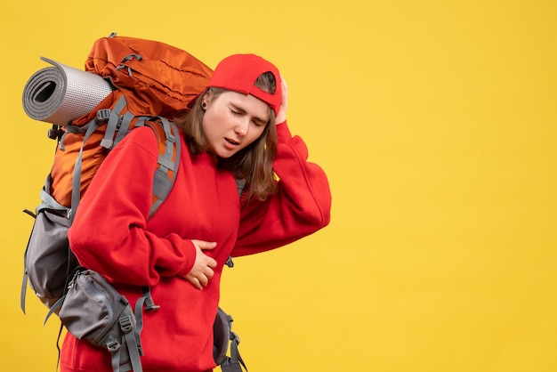 Free photo front view ailing traveller woman in red backpack holding her stomach and head