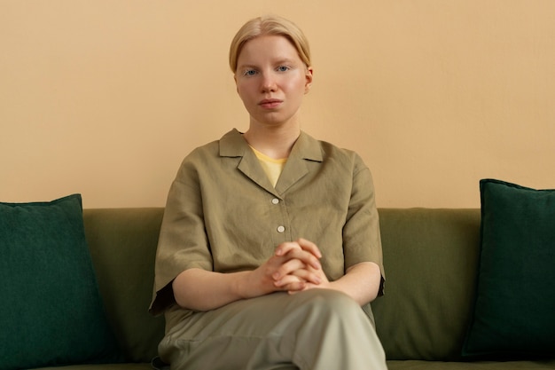 Front view albino woman posing at home