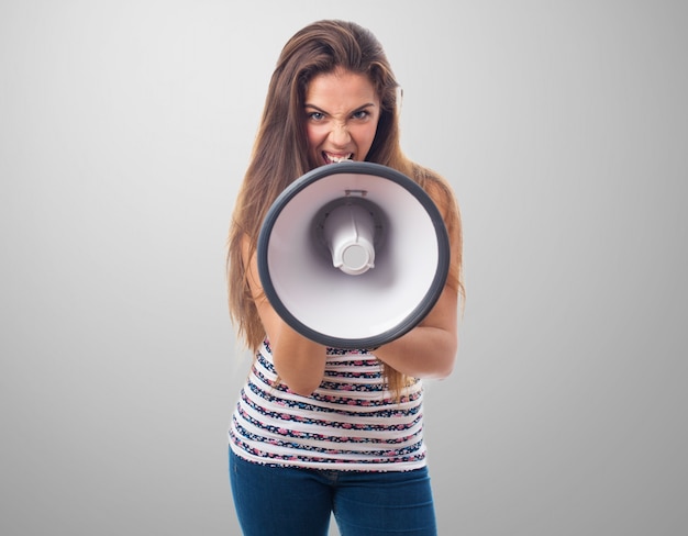 Front view of angry teenager with a megaphone