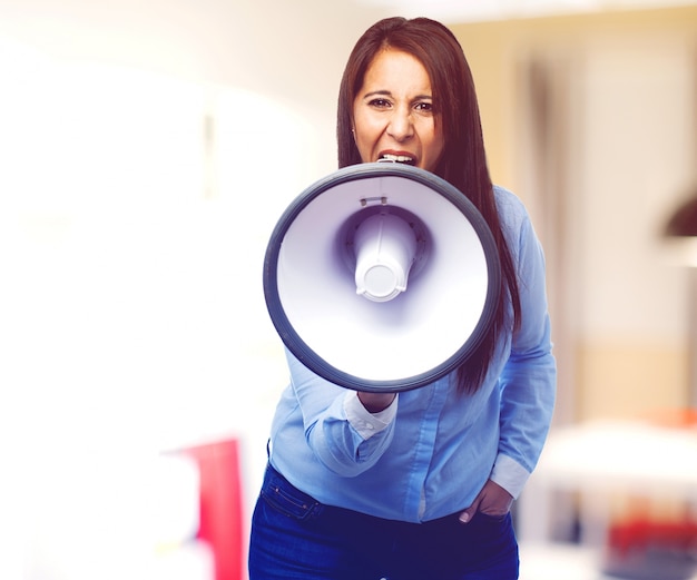 Front view of an angry woman with a bullhorn