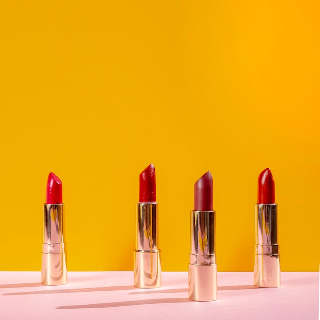 Free photo front view arrangement of different lipsticks