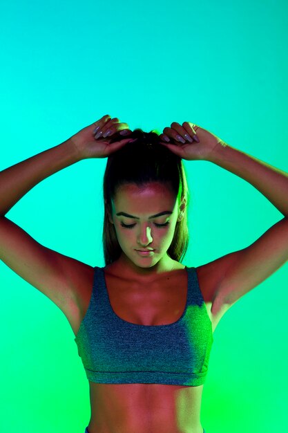 Front view of athlete tying her hair