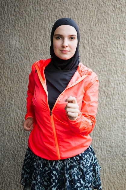 Front view of athlete with red jacket