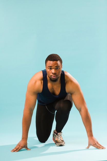 Front view of athletic man preparing to run