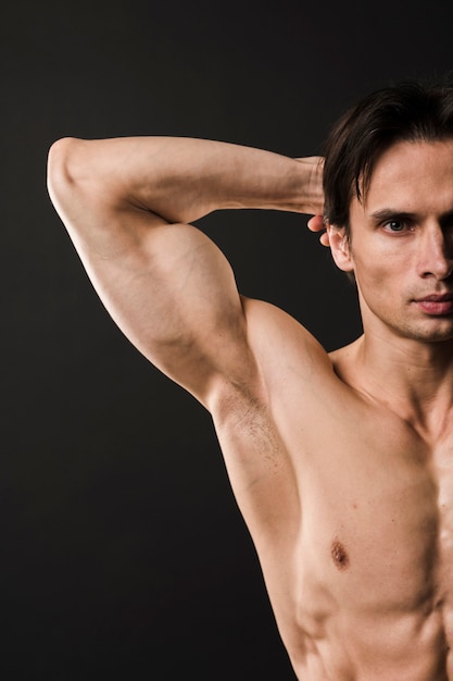 Free photo front view of athletic man showing off bicep