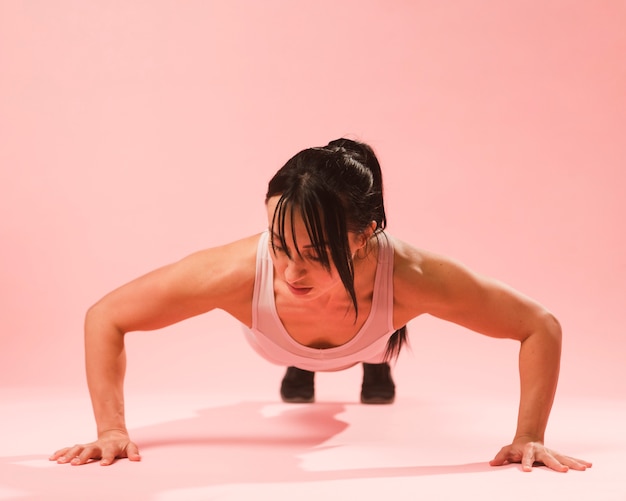 Front view of athletic woman doing push up
