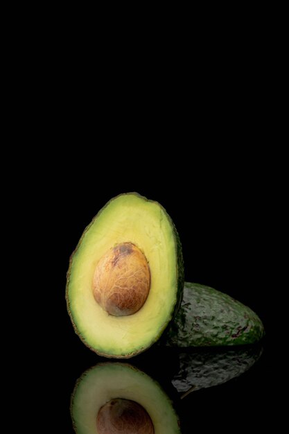 Front view of avocado with pit and copy space