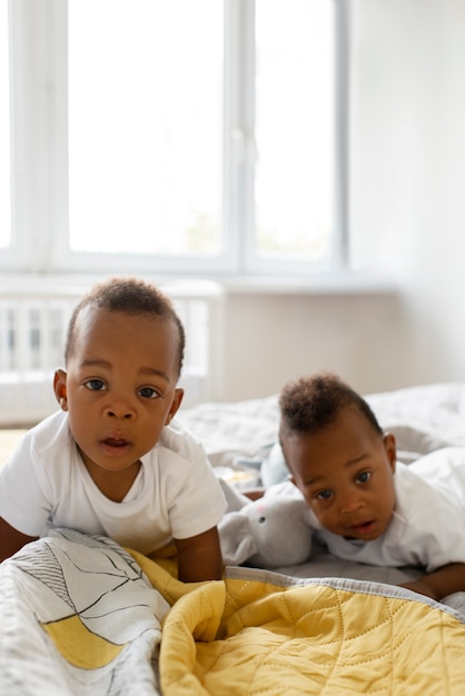 Front view babies laying in bed