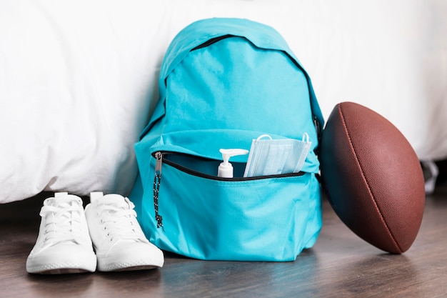 Free photo front view back to school arrangement with blue backpack