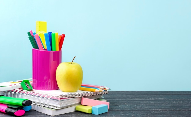 Front view of back to school stationery with apple and pencils