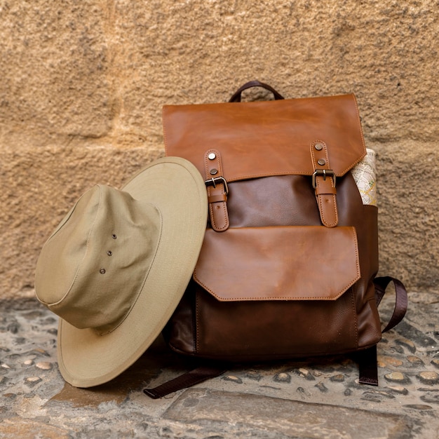 Front view backpack and hat on ground