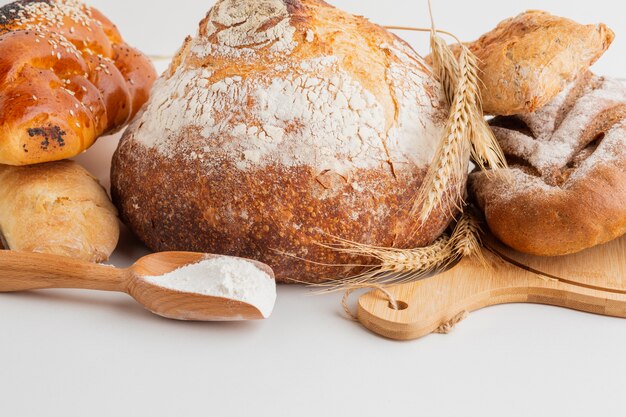 Front view of baked bread with wooden spoon